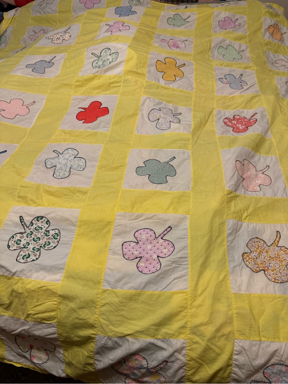 vintage hand-appliquéd and embroidered patchwork quilt top featuring a four-leaf